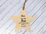 a wooden star ornament hanging from a string