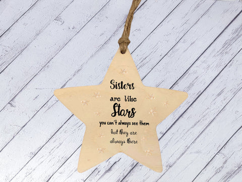 a wooden star ornament with a saying on it