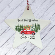 a ceramic star ornament with a red car and a christmas tree on it