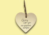 a ceramic heart hanging on a string