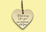 a ceramic heart hanging on a string