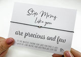 a woman holding a card with a message on it
