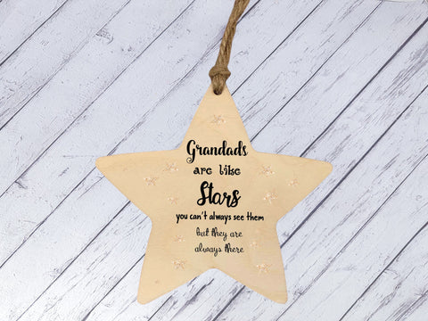 a wooden star ornament hanging on a string